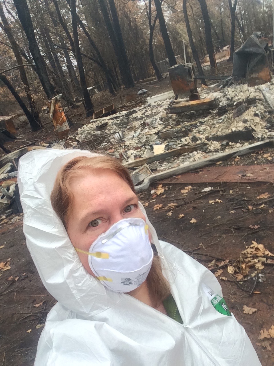 Artist in front of destroyed studio